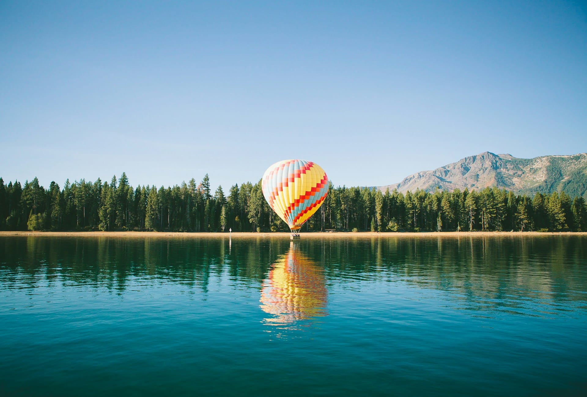 Hot air balloon on the edge of a lake