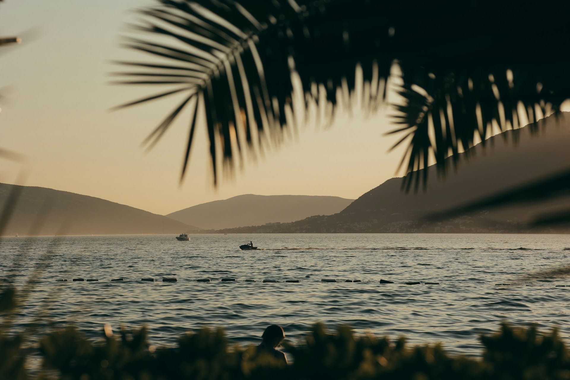 Body of water at sunset with boats