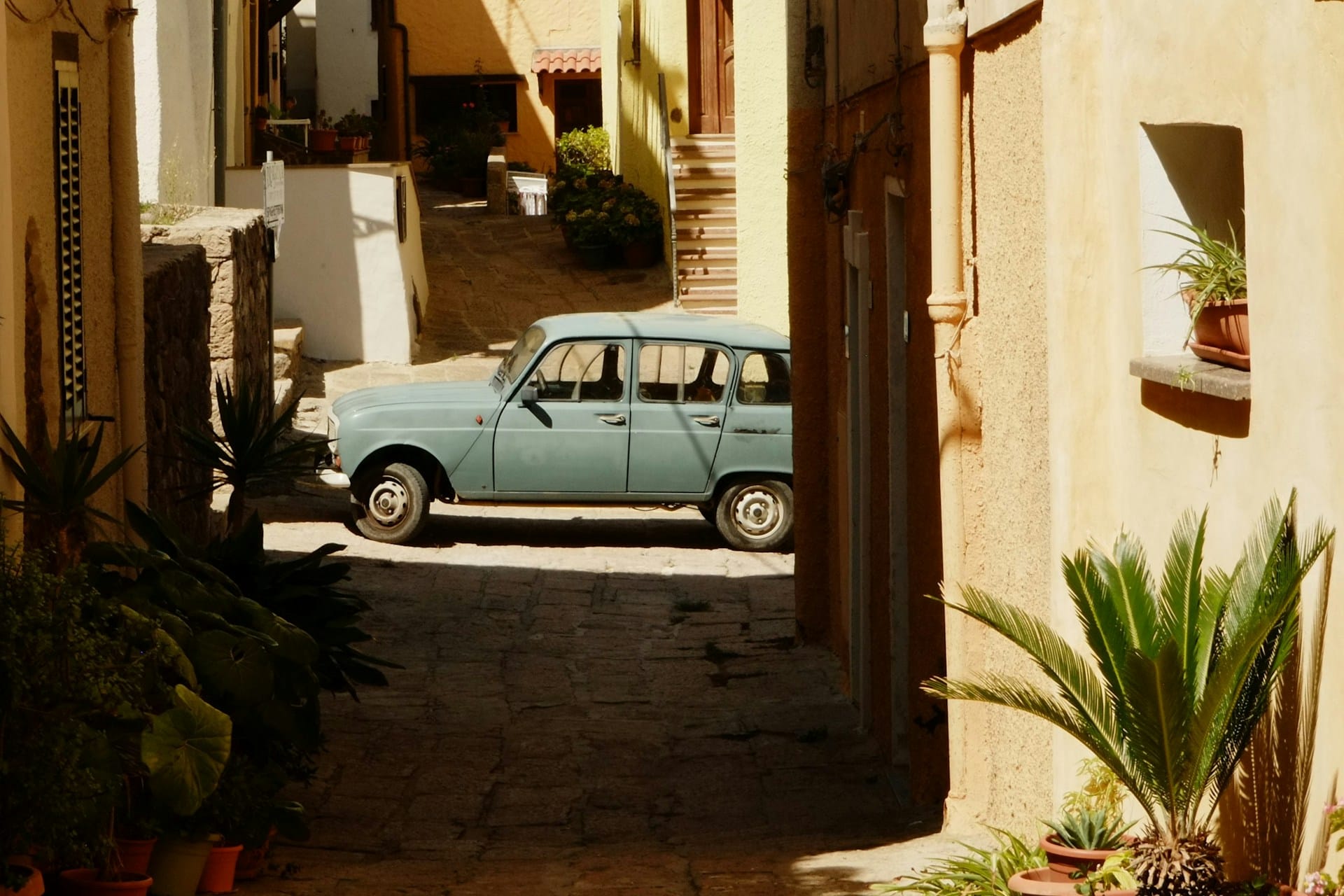 Older car parked in an alley