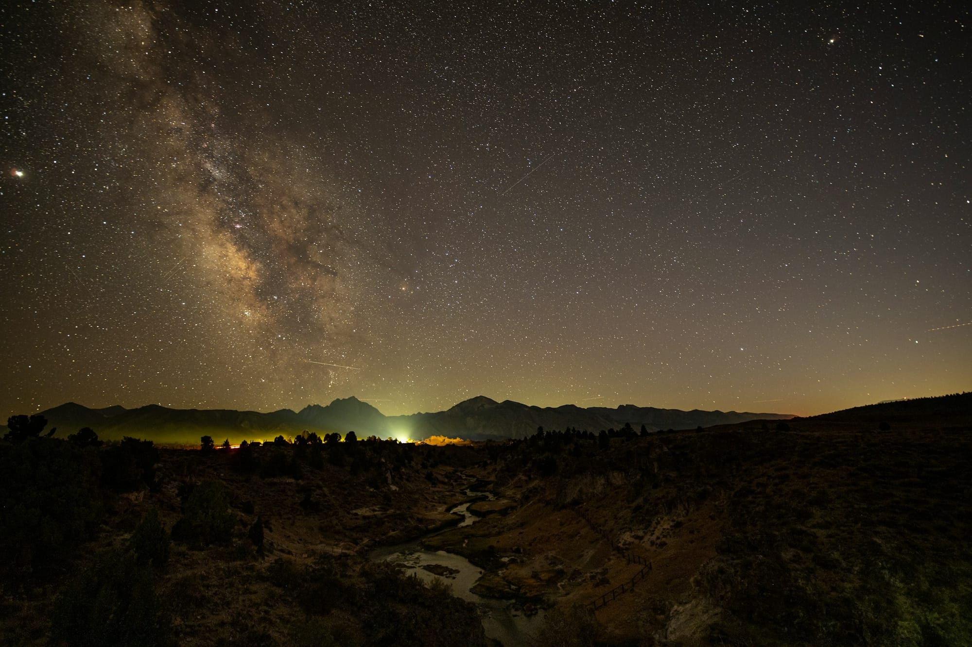 View of the night sky with lights below