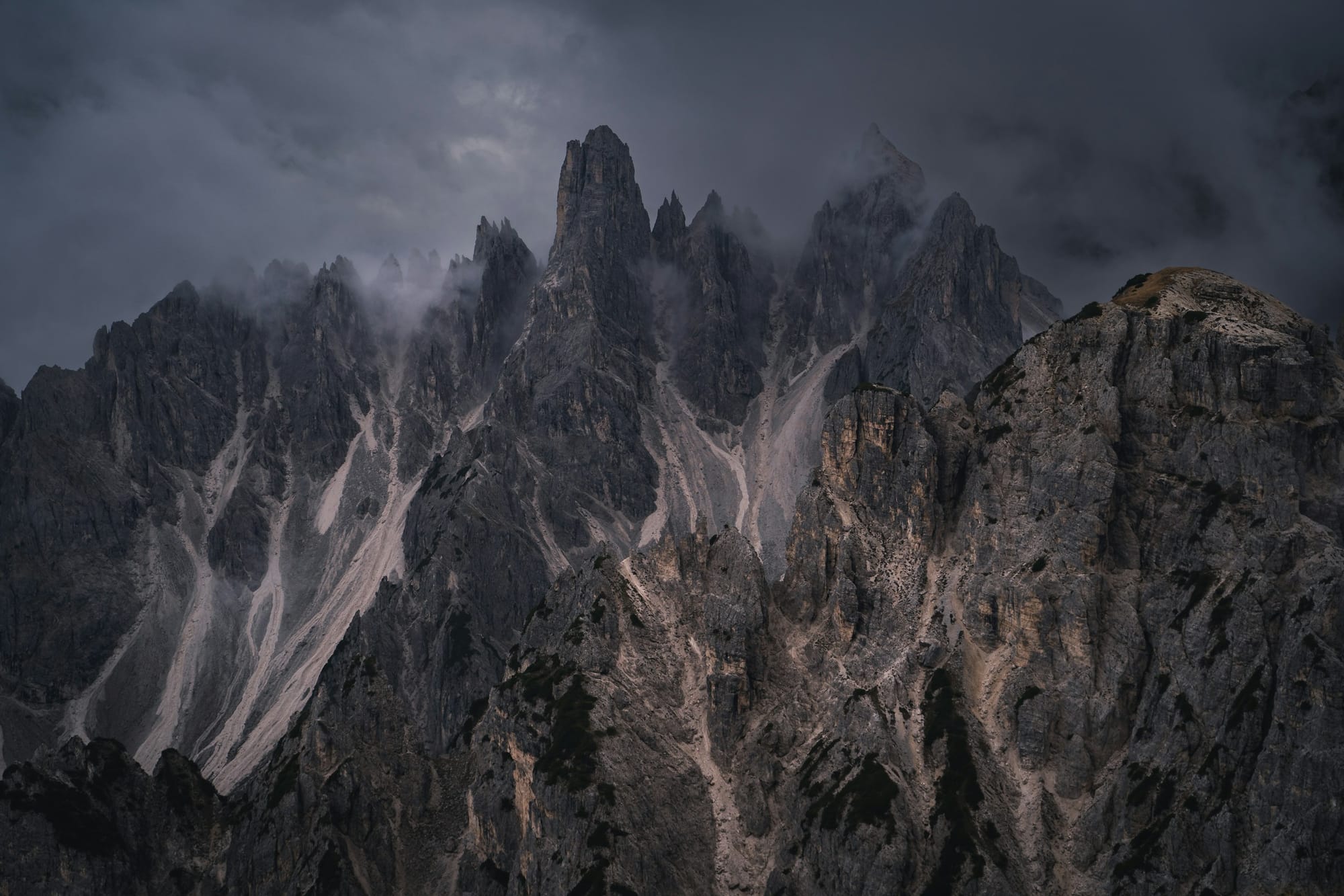 Low clouds over a rocky mountain range in Italy