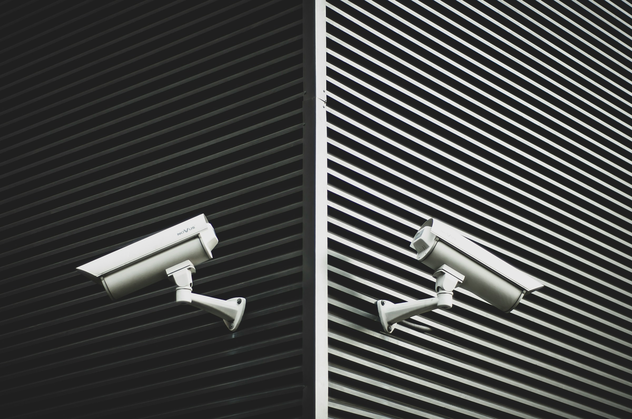 Two security cameras on a corner of a building